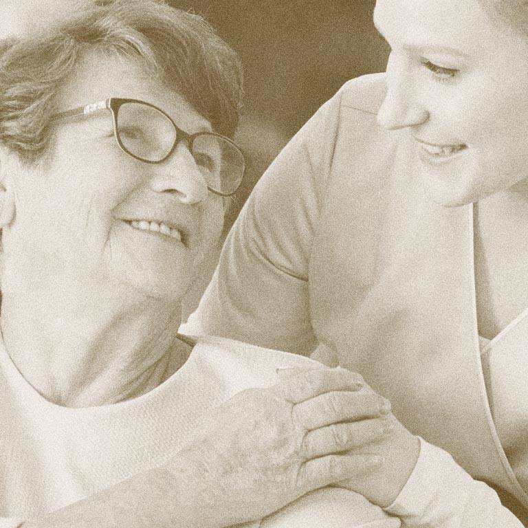 A resident being helped by an employee at our Carrier Mills facility. Contact Carrier Mills for more information about joining our community.